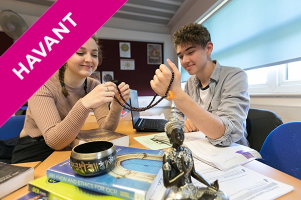 two students holding a religious artefact