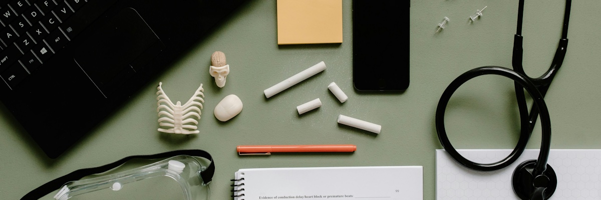 A desk with a laptop and scientific study equipment.