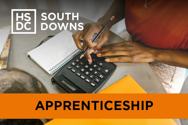 An accounting apprentice typing on a calculator.