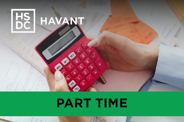 An accounting student working on a red calculator.