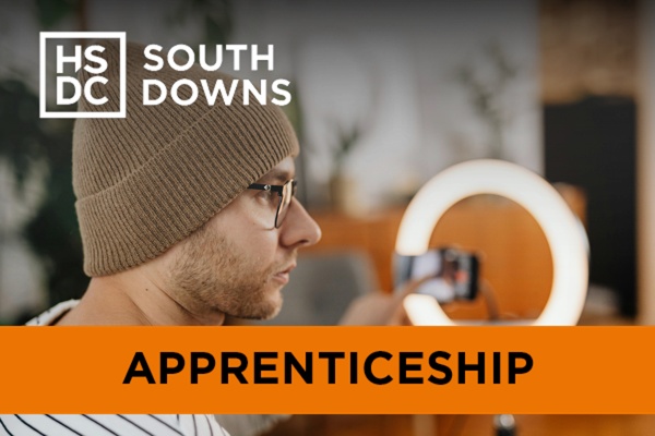 A man standing in front of a ring light.