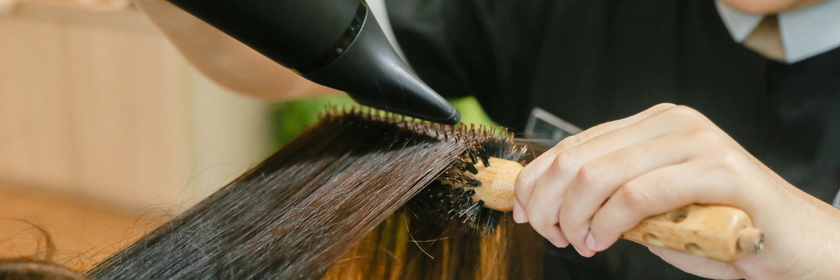 a closeup of a student styling hair