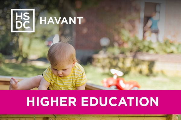 A child climbing out of a sandpit.