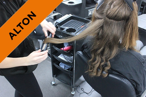 A student curling a client's hair