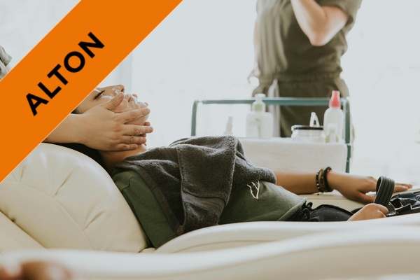 A beauty student giving a facial treatment.