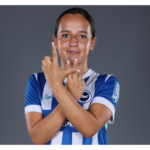 Student footballer Libby Hester poses in front of a studio background.