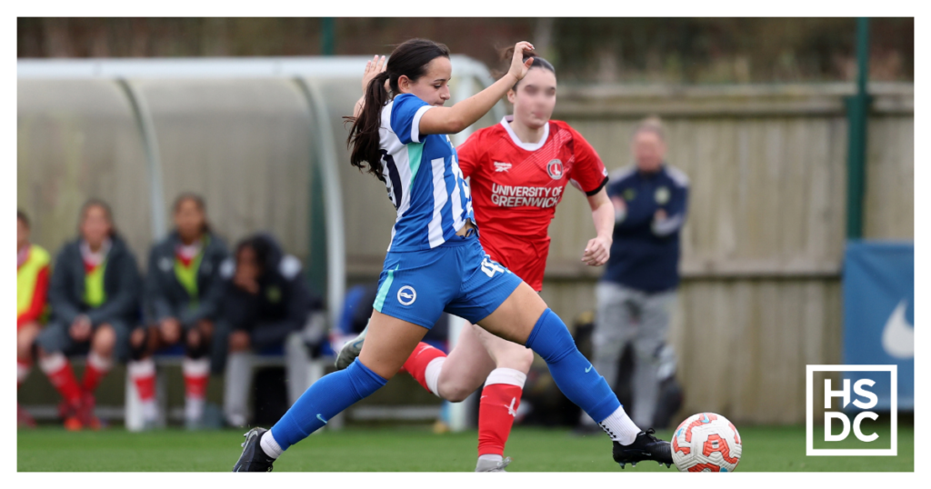 Student footballer Libby Hester kicking the ball.