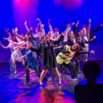 a group of musical theatre students performing on stage