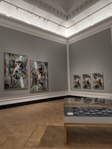 A group of classical paintings in a museum.