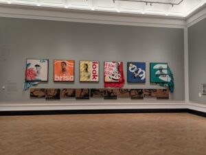 A group of bright graphic prints in a museum.