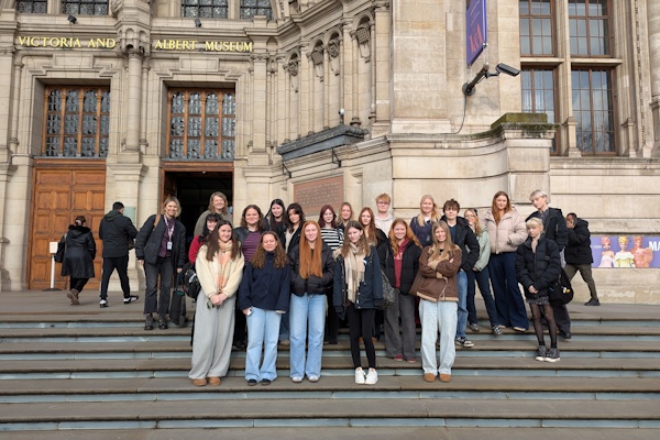 A group of students pose outside the Victoria & Albert Museum.
