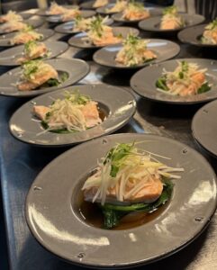 Plates of food prepared by HSDC students for the headteacher's dinner.