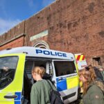 students exploring a police van