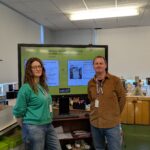 Two HSDC Art Lecturers pose in front of a presentation screen.