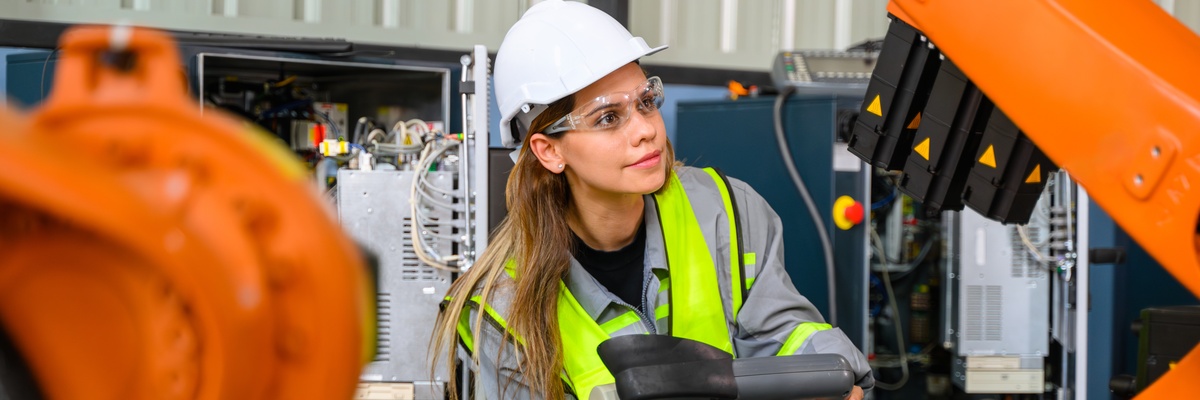A technician working on machinery in a factory/