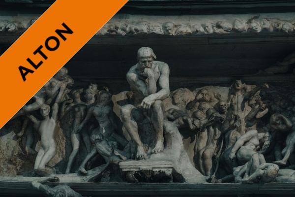 A large sculpture with a figure thinking in the centre, surrounded by figures in various poses.