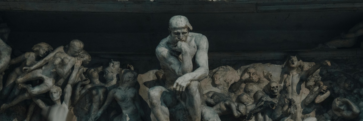 A large sculpture with a figure thinking in the centre, surrounded by figures in various poses.