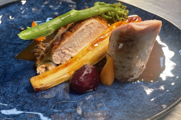Restaurant-style roast poultry dish served with seasonal vegetables and gravy.