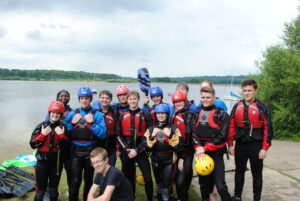 A group of students in life vests after a water based sport activity.