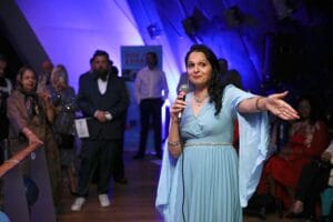 HSDC lecturer and charity owner Nadia giving a speech at the Road From Karachi event.