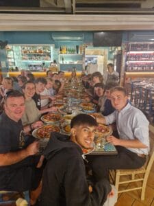 Geology students eating pizza on their trip to Sicily